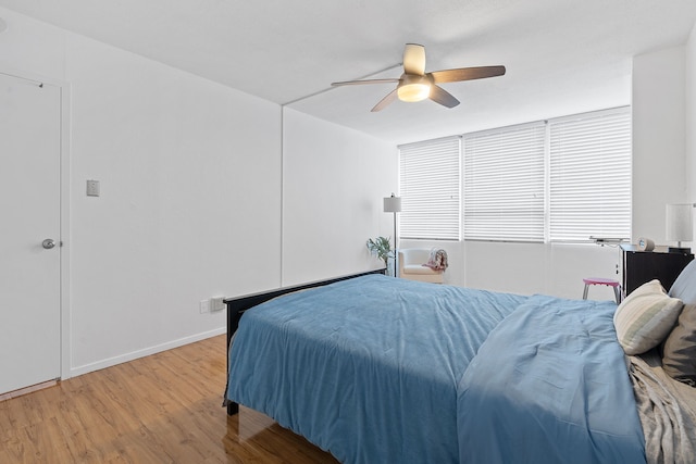 bedroom with wood-type flooring and ceiling fan