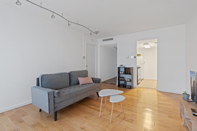 living room featuring track lighting and hardwood / wood-style floors