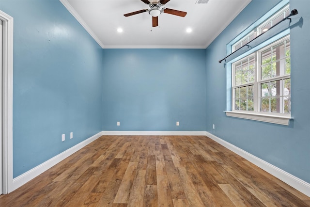 empty room with ceiling fan, hardwood / wood-style floors, and crown molding