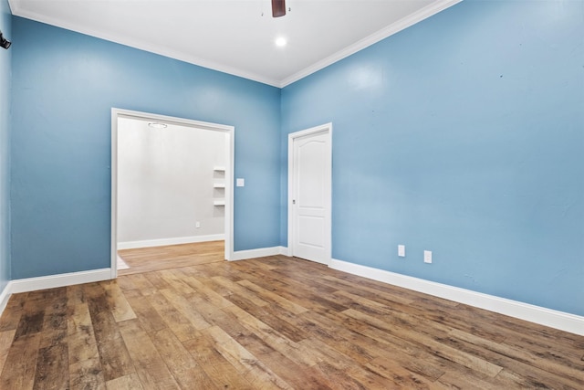 unfurnished room with hardwood / wood-style flooring, ceiling fan, and ornamental molding