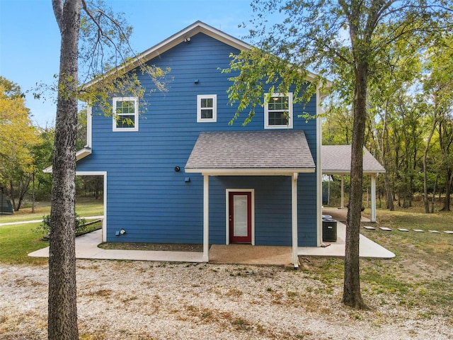 view of property with cooling unit and a patio area