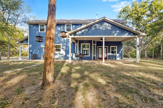 back of property with ceiling fan, a patio, central air condition unit, and a lawn