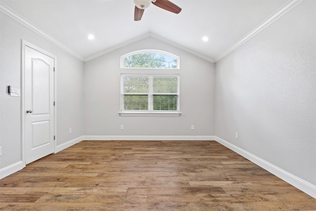 unfurnished room with lofted ceiling, ornamental molding, and hardwood / wood-style floors