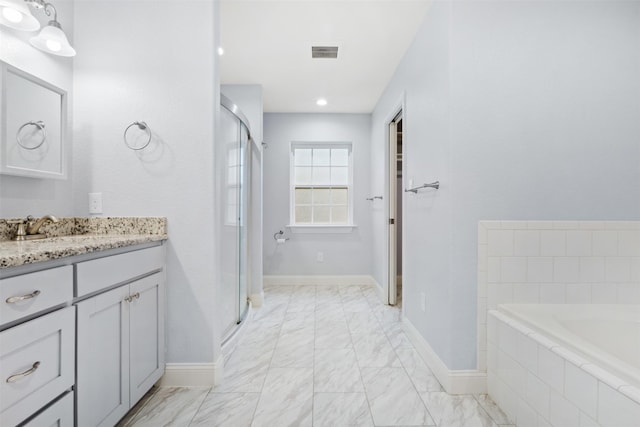 bathroom with vanity and separate shower and tub