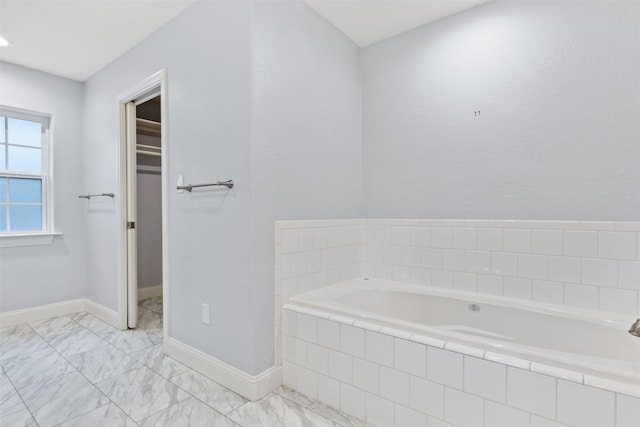 bathroom with a relaxing tiled tub