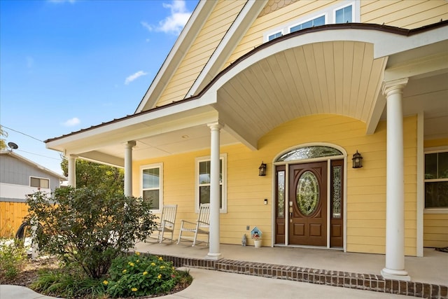 view of exterior entry with a porch