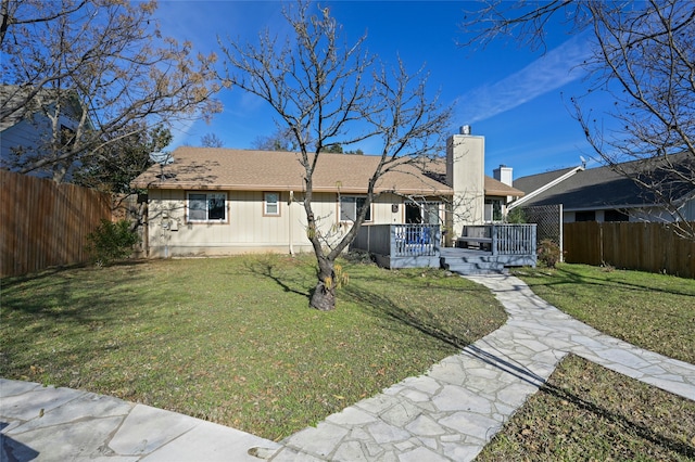 single story home featuring a deck and a front yard