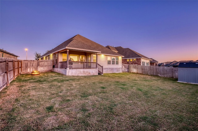 back house at dusk with a yard