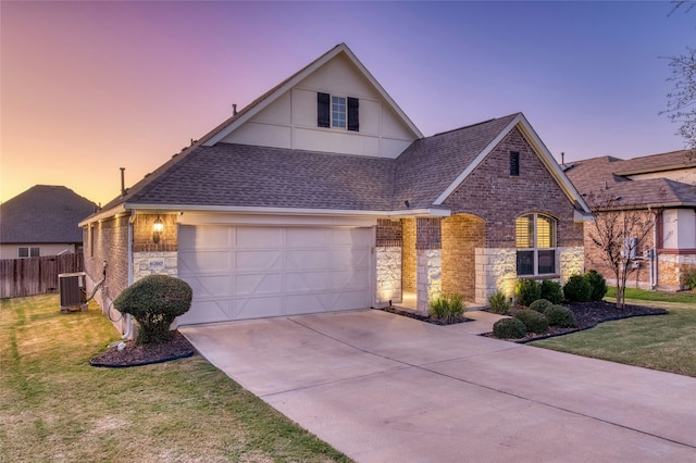 view of front of home featuring a lawn and cooling unit