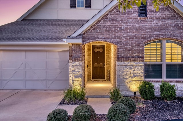 exterior entry at dusk with a garage