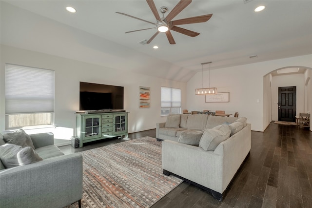 living room featuring lofted ceiling, ceiling fan, and dark hardwood / wood-style floors