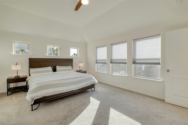 carpeted bedroom featuring lofted ceiling and ceiling fan