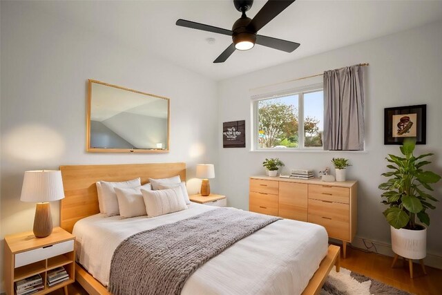 bedroom with ceiling fan and hardwood / wood-style floors