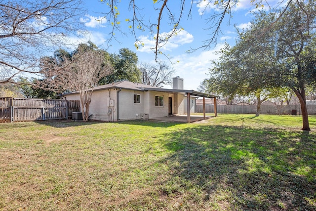 back of house with a lawn, central AC, and a patio area