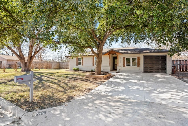 ranch-style house featuring a garage and a front lawn