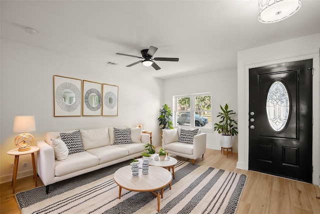 living room with light wood-type flooring and ceiling fan