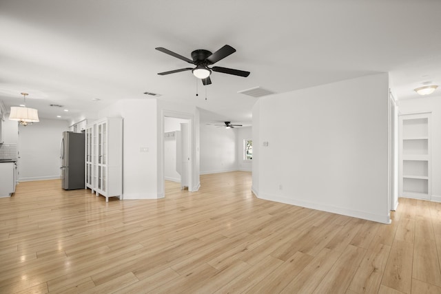 unfurnished living room featuring light wood-type flooring and ceiling fan