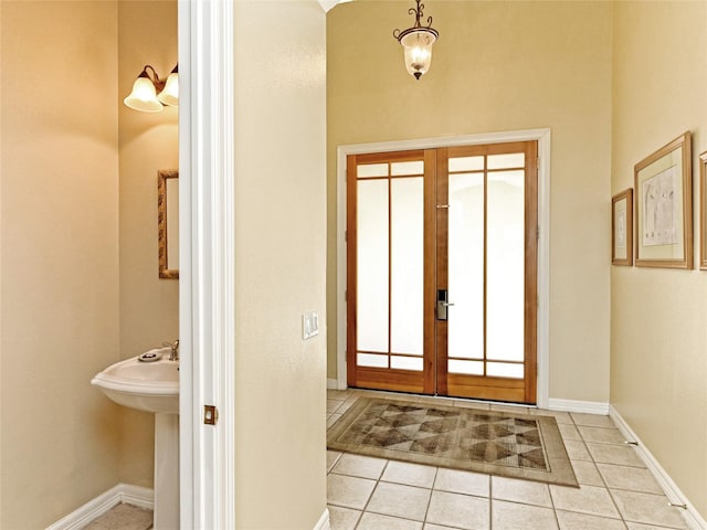 entrance foyer featuring french doors and light tile patterned flooring