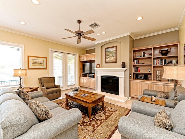 tiled living room featuring ceiling fan and crown molding