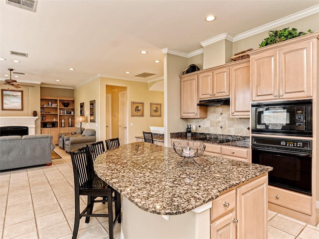 kitchen featuring a kitchen breakfast bar, black appliances, a kitchen island, light brown cabinets, and light tile patterned flooring