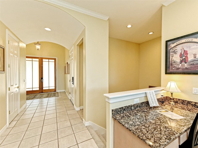 foyer entrance featuring ornamental molding, light tile patterned flooring, and french doors