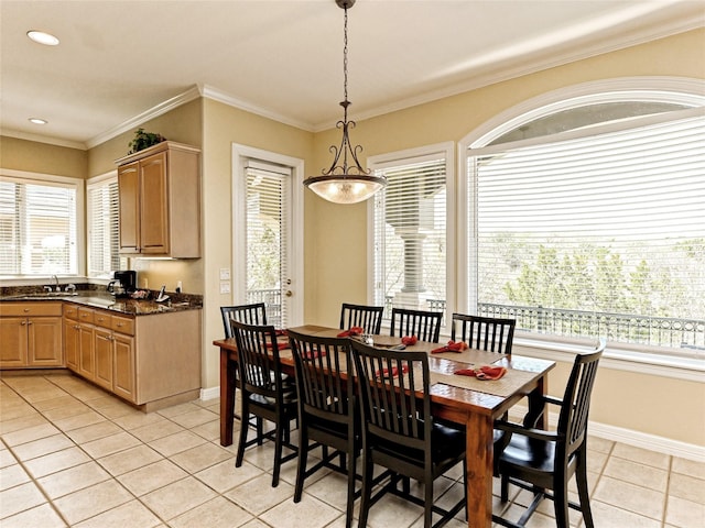 dining space with ornamental molding, an inviting chandelier, light tile patterned flooring, and sink