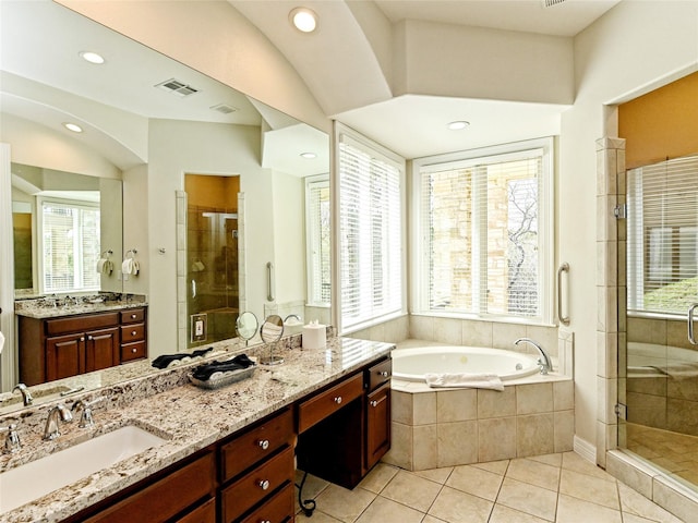 bathroom featuring lofted ceiling, tile patterned floors, plus walk in shower, and vanity