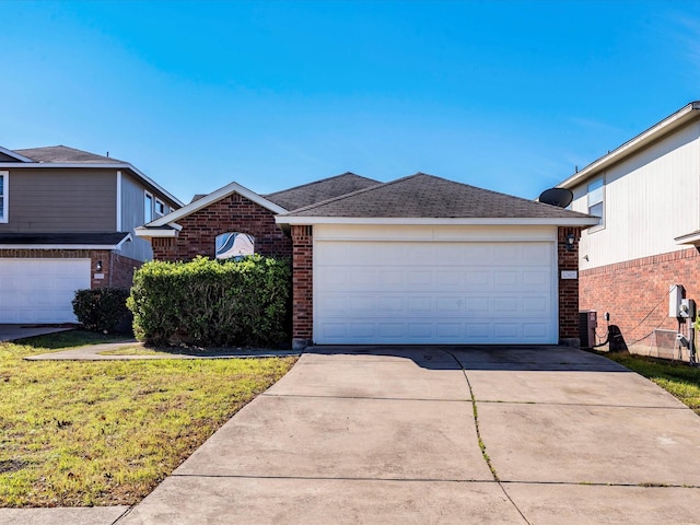 view of front of house featuring a garage and a front lawn