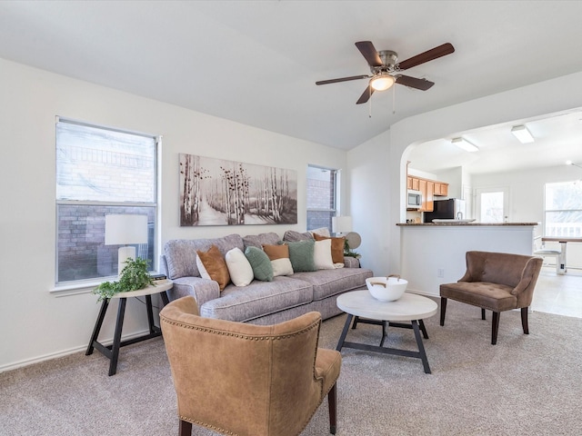 living room featuring ceiling fan and light colored carpet