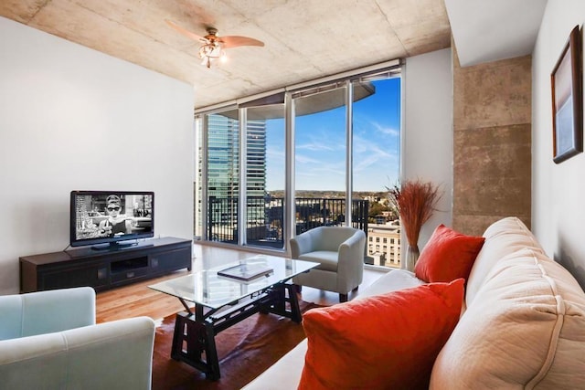 living room featuring hardwood / wood-style floors, floor to ceiling windows, and ceiling fan