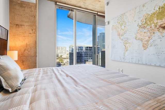 bedroom featuring access to outside and a wall of windows