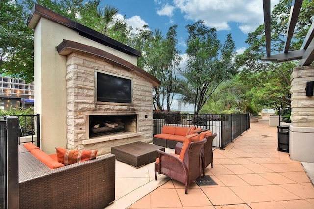 view of patio featuring an outdoor living space with a fireplace