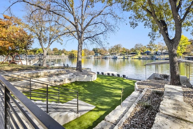 exterior space featuring a lawn and a water view