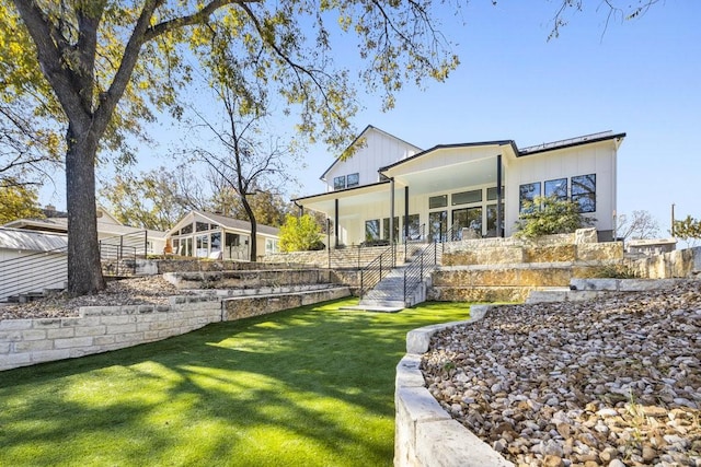 exterior space featuring covered porch and a lawn