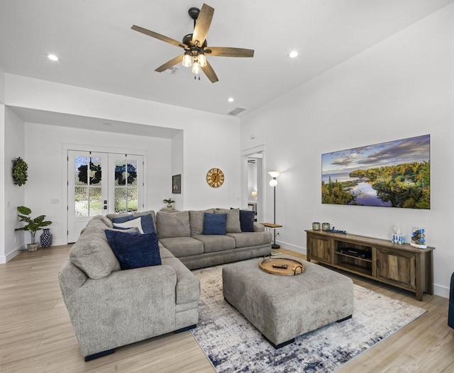 living room with ceiling fan, light hardwood / wood-style floors, and french doors