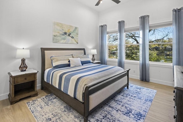 bedroom with ceiling fan and light hardwood / wood-style flooring