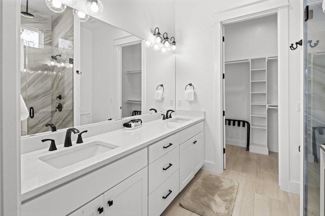 bathroom with walk in shower and vanity