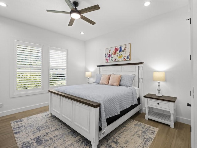 bedroom featuring ceiling fan and dark hardwood / wood-style floors