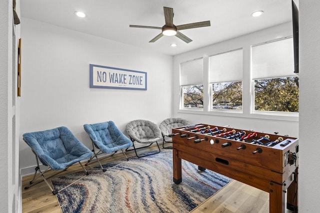 rec room with hardwood / wood-style flooring and ceiling fan