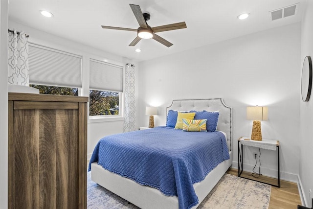 bedroom with ceiling fan and light wood-type flooring