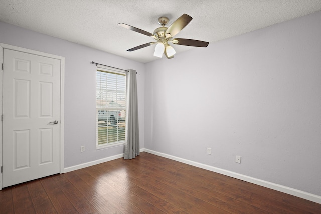 unfurnished room featuring dark wood-type flooring, a textured ceiling, and ceiling fan