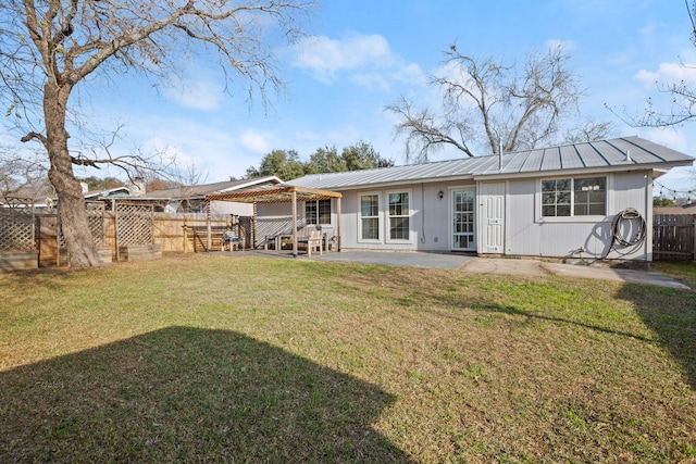 back of house with a yard and a patio area