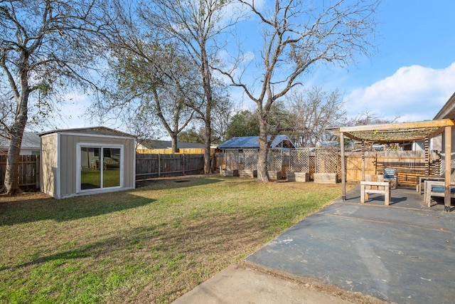 view of yard featuring a storage unit and a patio area