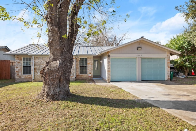 single story home featuring a garage and a front lawn