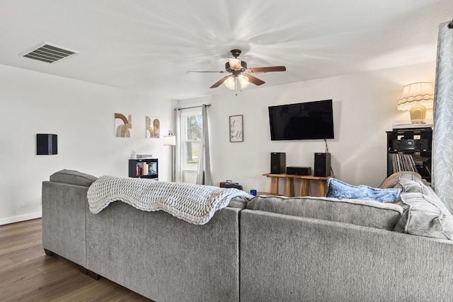 living room with dark hardwood / wood-style floors and ceiling fan