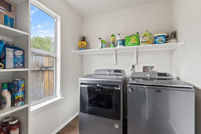 laundry room featuring dark wood-type flooring and washer and clothes dryer