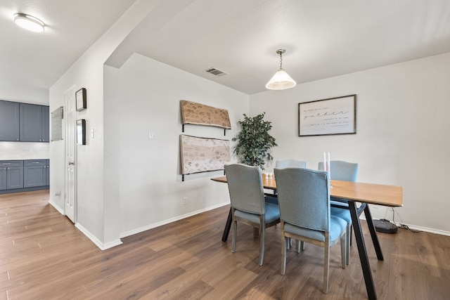 dining space with wood-type flooring