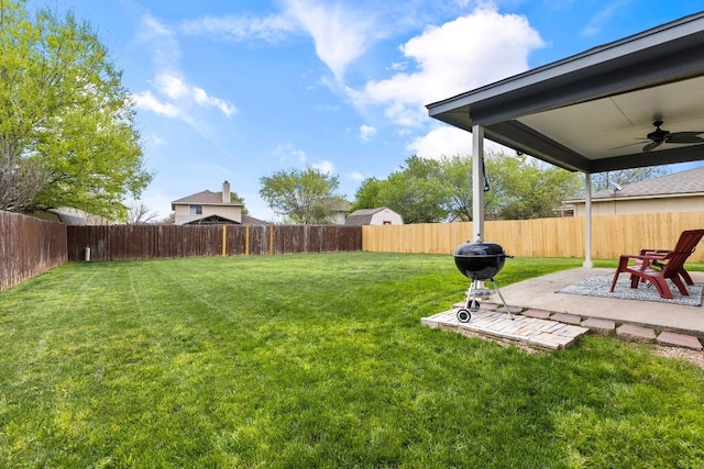 view of yard with ceiling fan and a patio area