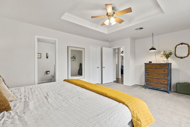 bedroom with a raised ceiling, crown molding, carpet flooring, and ceiling fan