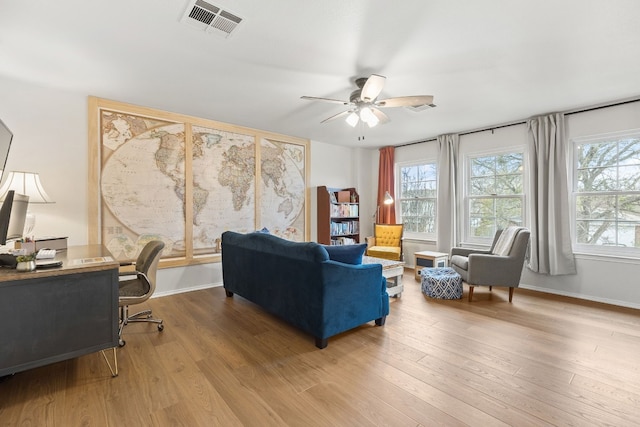 home office with hardwood / wood-style floors, a wealth of natural light, and ceiling fan